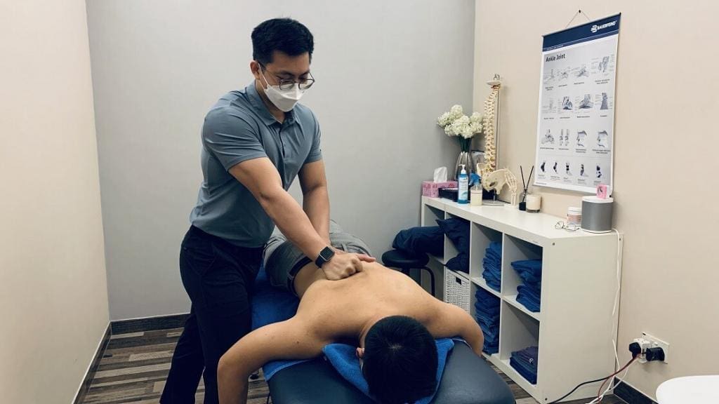 Physiotherapist treating back pain with Physiotherapy 